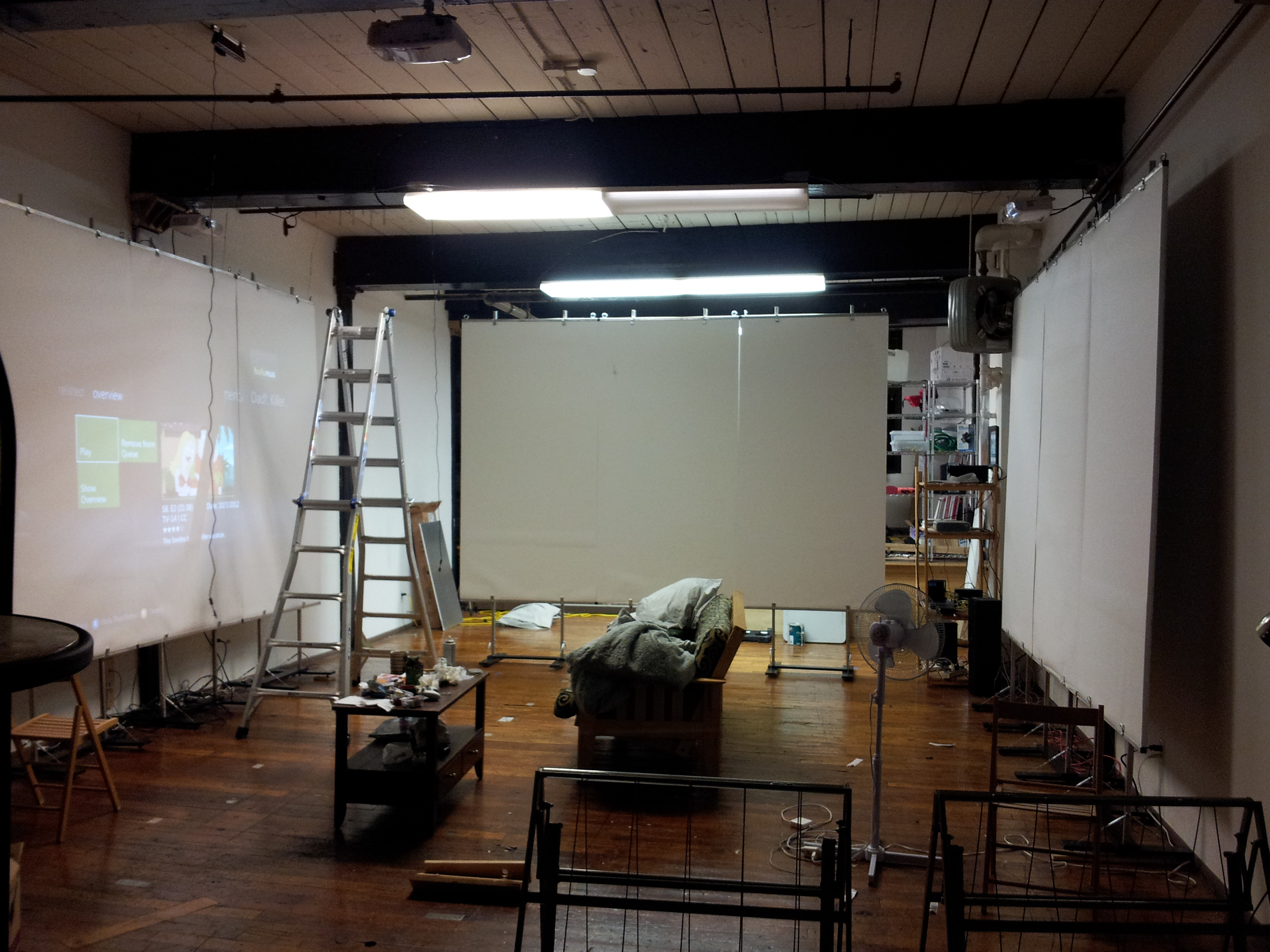 space full of projector screens and equipment